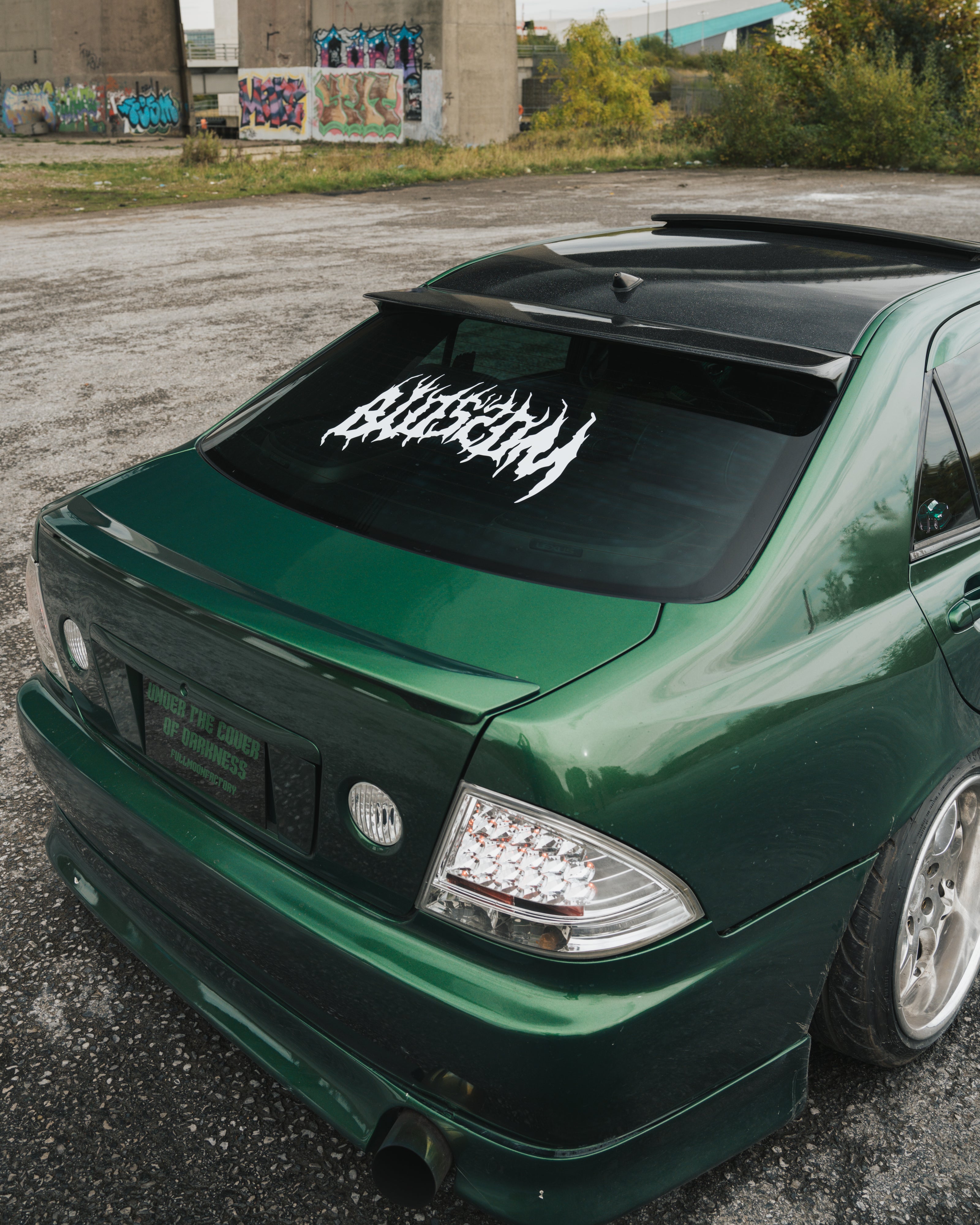 Blossom Automotive Xl window sticker stuck on a green Lexus is200