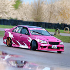 Pink car with white flames on a track