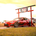 Red sports car with Zoku livery on it