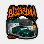 A dark green sports car from Blossom Automotive's The Skate Collection - Slap Sticker is parked by graffiti walls, a skateboard nearby. A volcano smokes under an orange Blossom logo and neon Japanese text glows in the background.