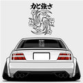 A widebody white sports car seen from the rear features the Blossom Automotive "Strength & Power Koi Fish" XL die-cut sticker on its window, with koi fish and Japanese tattoo-style flowers and text above the car.