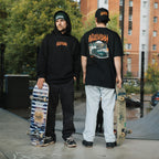 People standing in skatepark wearing Blossom Skate Collection black tee, hoodie, cap and beanie featuring Lexus IS200 graphic, oversized fit, inspired by skate and drift culture