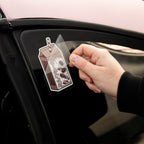 A hand peels a protective layer off a Blossom Automotive Cookies and Cream Milkshake - Slap Sticker that's attached to a car window.