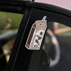 A large Blossom Automotive "Cookies and Cream Milkshake - Slap Sticker" with spilled milk, cookies, a striped straw, and stylized text decorates the car’s black window pillar.