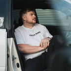 person wearing white Tokyo sushi collection t-shirt sat in white Toyota chaser